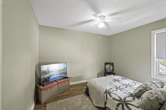 3364 85th Ave, Princeton, MN 55371 - bedroom with wood finished floors, a textured ceiling, ceiling fan, and baseboards