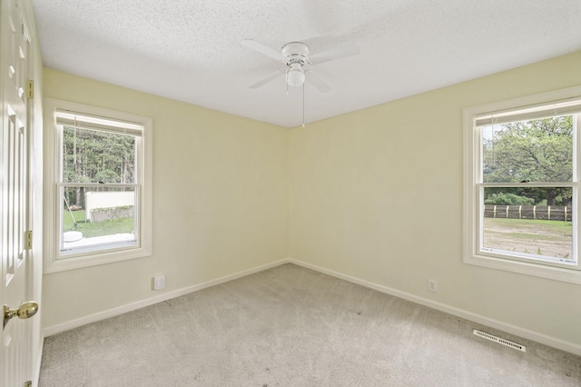 3364 85th Ave, Princeton, MN 55371 - spare room featuring light colored carpet, baseboards, ceiling fan, and a textured ceiling