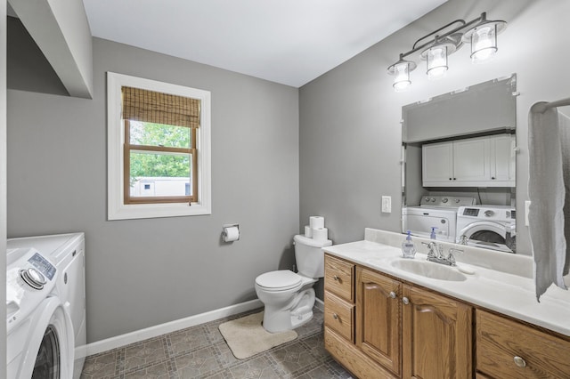 3364 85th Ave, Princeton, MN 55371 - bathroom featuring washer and clothes dryer, baseboards, toilet, and vanity
