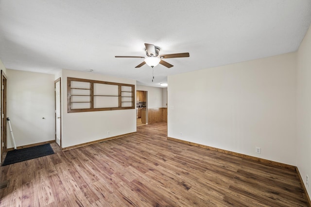 3364 85th Ave, Princeton, MN 55371 - unfurnished room featuring ceiling fan, wood finished floors, baseboards, and a wainscoted wall