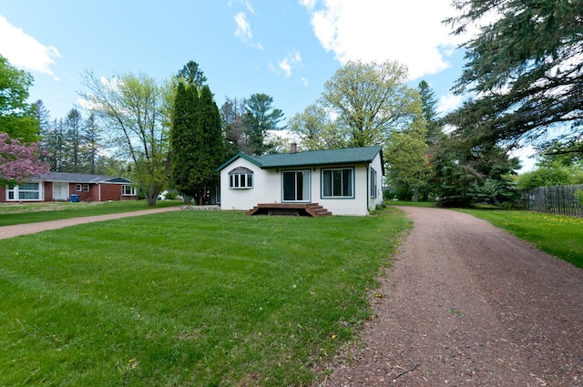 915 Knapp St, Rice Lake, WI 54868 - ranch-style house featuring dirt driveway, a chimney, and stucco siding