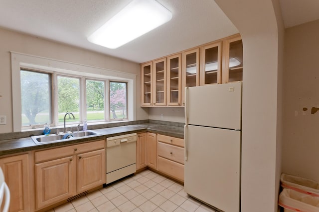 915 Knapp St, Rice Lake, WI 54868 - kitchen with white appliances, a sink, light brown cabinetry, and dark countertops
