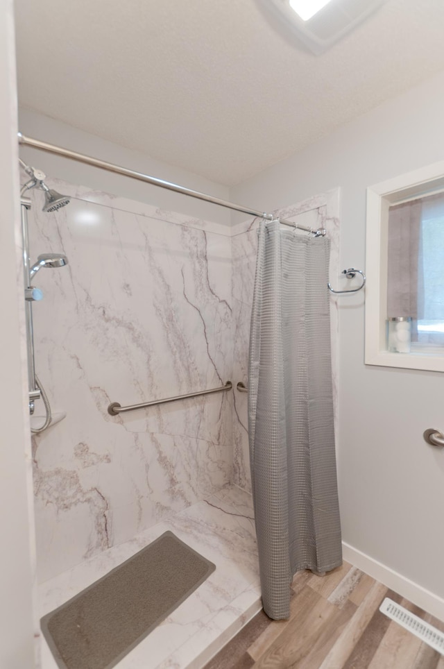 915 Knapp St, Rice Lake, WI 54868 - full bathroom featuring a marble finish shower and wood finished floors