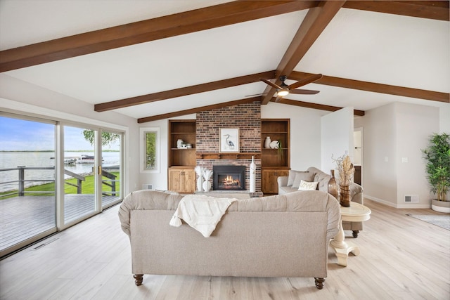 67854 217th St, Darwin, MN 55324 - living area featuring a water view, light wood finished floors, a fireplace, ceiling fan, and baseboards