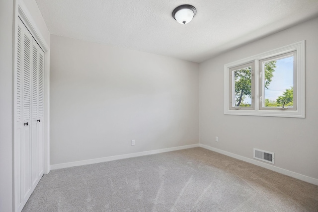 67854 217th St, Darwin, MN 55324 - unfurnished bedroom featuring carpet, baseboards, a closet, and a textured ceiling