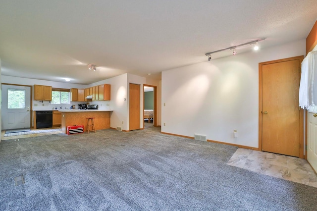 18917 Hartley Lake Rd, Brainerd, MN 56401 - kitchen with open floor plan, black dishwasher, light carpet, a peninsula, and light countertops