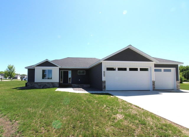 1707 17th St NW, Willmar, MN 56201 - ranch-style house featuring a garage, driveway, stone siding, and a front yard