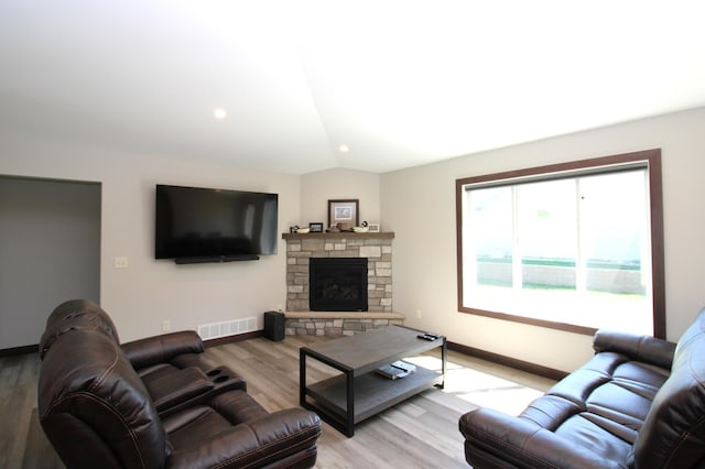1707 17th St NW, Willmar, MN 56201 - living area with baseboards, light wood-type flooring, lofted ceiling, a fireplace, and recessed lighting