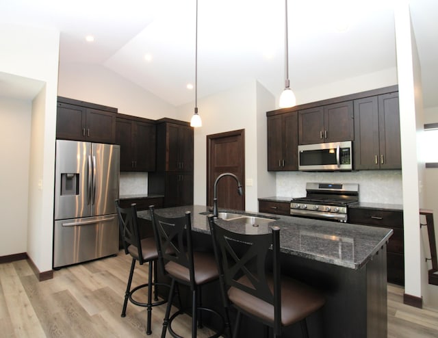 1707 17th St NW, Willmar, MN 56201 - kitchen with stainless steel appliances, a sink, tasteful backsplash, dark brown cabinets, and light wood finished floors