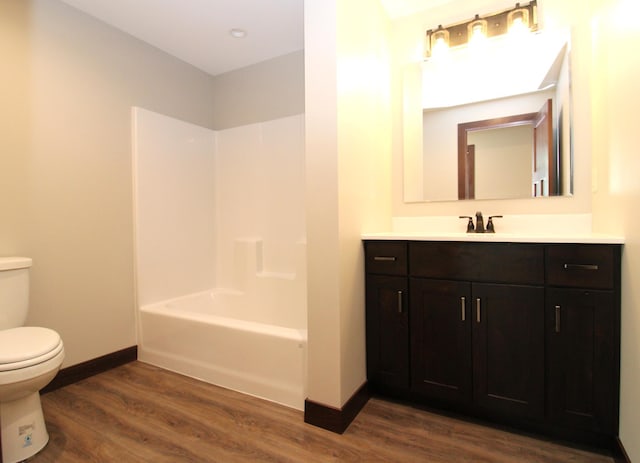 1707 17th St NW, Willmar, MN 56201 - full bathroom with toilet, wood finished floors, vanity, baseboards, and  shower combination