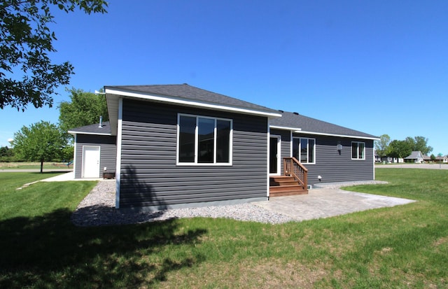 1707 17th St NW, Willmar, MN 56201 - rear view of house with a yard and a patio