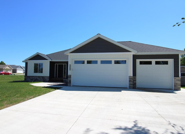 1707 17th St NW, Willmar, MN 56201 - view of front of house with a garage, stone siding, and driveway