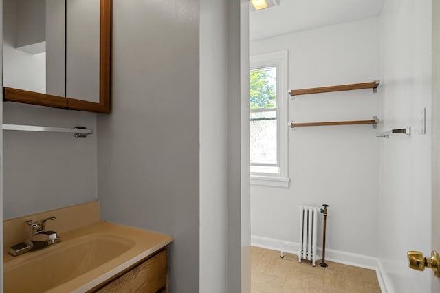 3545 Minnehaha Ave, Minneapolis, MN 55406 - bathroom featuring radiator heating unit, baseboards, and vanity