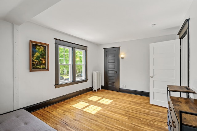 3545 Minnehaha Ave, Minneapolis, MN 55406 - unfurnished bedroom featuring radiator heating unit, light wood-style flooring, and baseboards