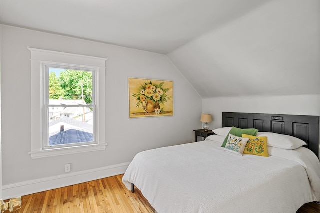 3545 Minnehaha Ave, Minneapolis, MN 55406 - bedroom featuring wood finished floors, vaulted ceiling, and baseboards