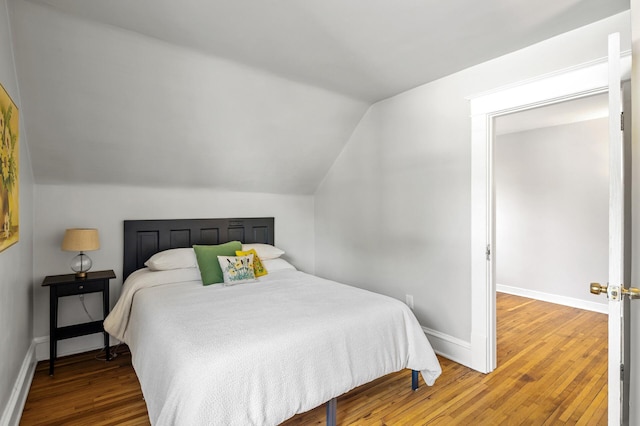 3545 Minnehaha Ave, Minneapolis, MN 55406 - bedroom featuring wood finished floors, vaulted ceiling, and baseboards