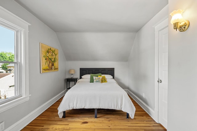 3545 Minnehaha Ave, Minneapolis, MN 55406 - bedroom with vaulted ceiling, wood finished floors, and baseboards
