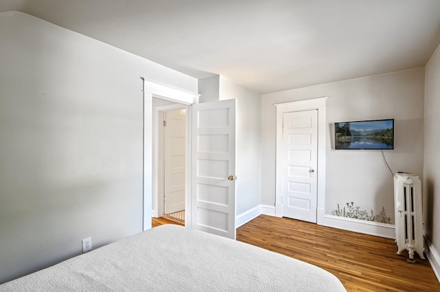 3545 Minnehaha Ave, Minneapolis, MN 55406 - bedroom featuring wood finished floors, baseboards, and radiator heating unit