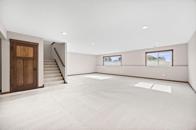 249 3rd St SW, Delano, MN 55328 - unfurnished living room with carpet flooring, stairway, healthy amount of natural light, and recessed lighting