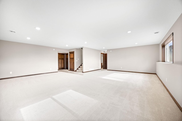 249 3rd St SW, Delano, MN 55328 - spare room featuring stairway, light colored carpet, baseboards, and recessed lighting