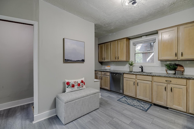1066 Reaney Ave, Saint Paul, MN 55106 - kitchen featuring stainless steel dishwasher, a sink, light wood-style floors, decorative backsplash, and light brown cabinetry