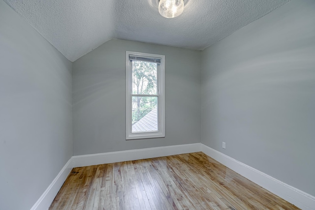1066 Reaney Ave, Saint Paul, MN 55106 - additional living space with a textured ceiling, wood-type flooring, lofted ceiling, and baseboards