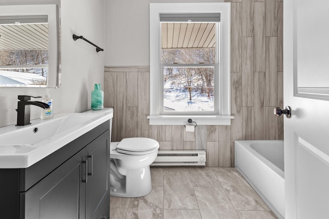 781 7th St, Red Wing, MN 55066 - bathroom with baseboard heating, vanity, toilet, and a tub