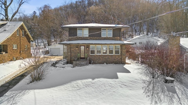 781 7th St, Red Wing, MN 55066 - view of front of home with a garage, an outdoor structure, and brick siding