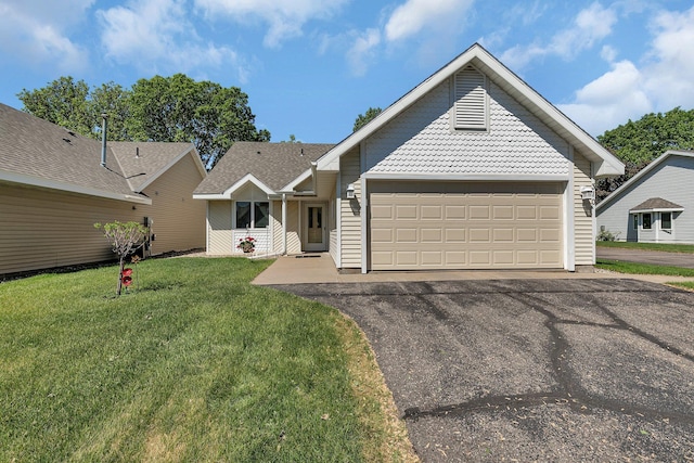 310 Park Ave S, Saint Cloud, MN 56301 - view of front of home featuring asphalt driveway, an attached garage, and a front yard
