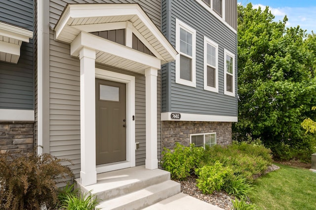 7602 Connie Ln, Inver Grove Heights, MN 55076 - doorway to property featuring stone siding and board and batten siding