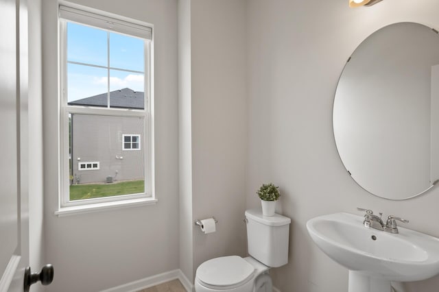 7602 Connie Ln, Inver Grove Heights, MN 55076 - bathroom with a sink, toilet, and baseboards