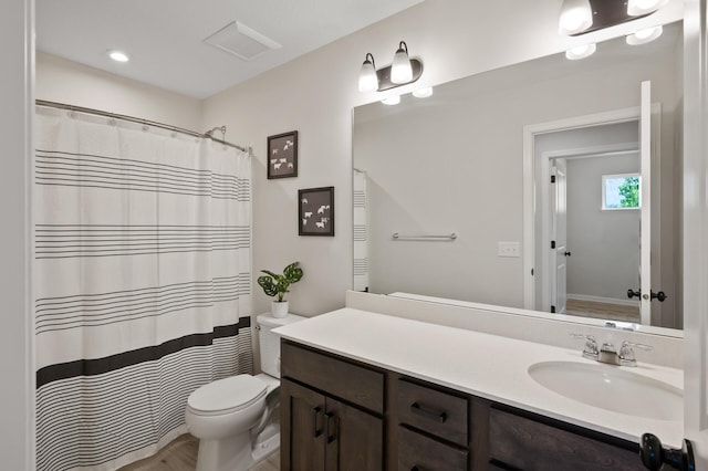7602 Connie Ln, Inver Grove Heights, MN 55076 - bathroom with vanity, toilet, curtained shower, and wood finished floors