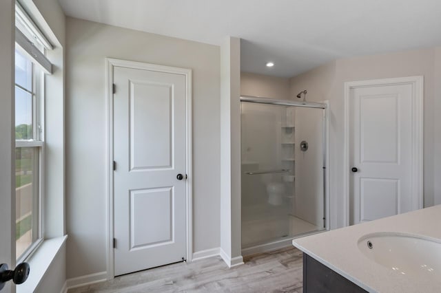 7602 Connie Ln, Inver Grove Heights, MN 55076 - bathroom featuring plenty of natural light, a stall shower, wood finished floors, vanity, and recessed lighting