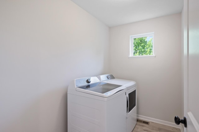 7602 Connie Ln, Inver Grove Heights, MN 55076 - laundry room featuring separate washer and dryer, light wood-style flooring, and baseboards