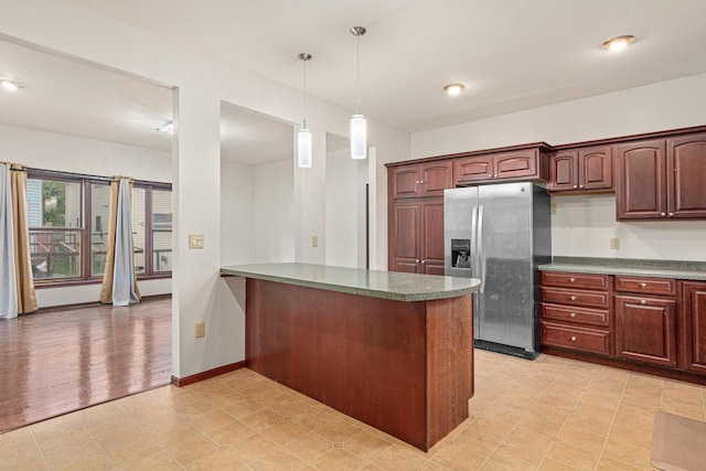 338 Aurora Ave, Saint Paul, MN 55103 - kitchen featuring stainless steel fridge, pendant lighting, a peninsula, dark countertops, and baseboards