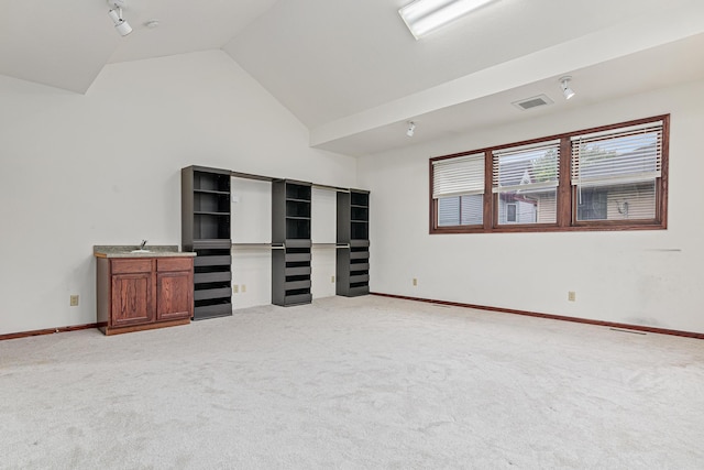 338 Aurora Ave, Saint Paul, MN 55103 - unfurnished living room featuring light carpet, vaulted ceiling, and baseboards