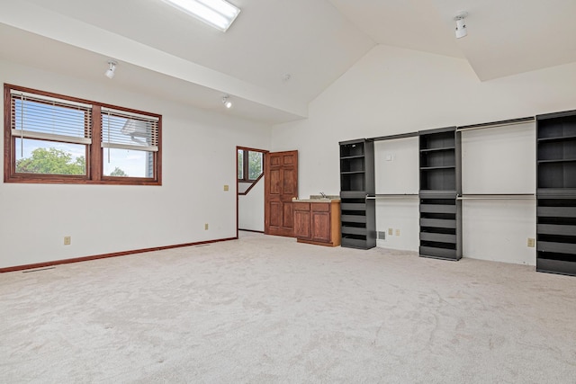 338 Aurora Ave, Saint Paul, MN 55103 - unfurnished bedroom with light colored carpet, high vaulted ceiling, and baseboards
