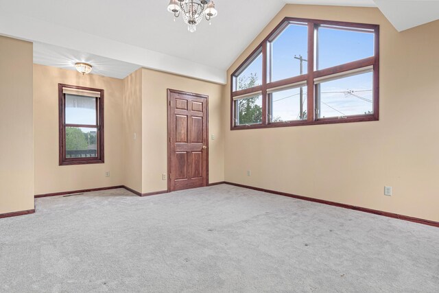 338 Aurora Ave, Saint Paul, MN 55103 - carpeted spare room featuring lofted ceiling, baseboards, and a chandelier