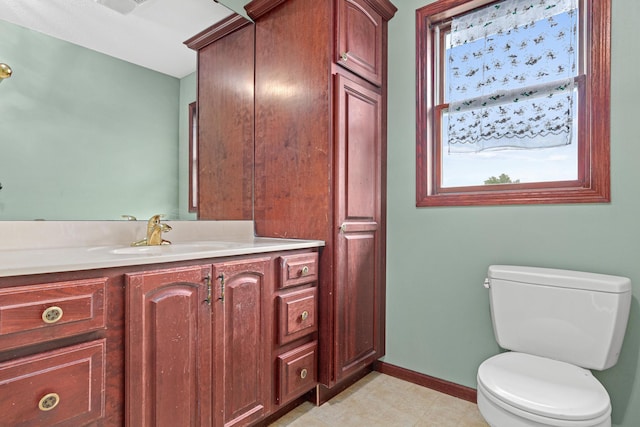 338 Aurora Ave, Saint Paul, MN 55103 - bathroom featuring toilet, vanity, baseboards, and tile patterned floors