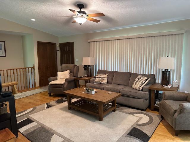 26722 Eisenmen Dr, Leonard, MN 56652 - living area featuring a ceiling fan, light wood-style flooring, lofted ceiling, and a textured ceiling