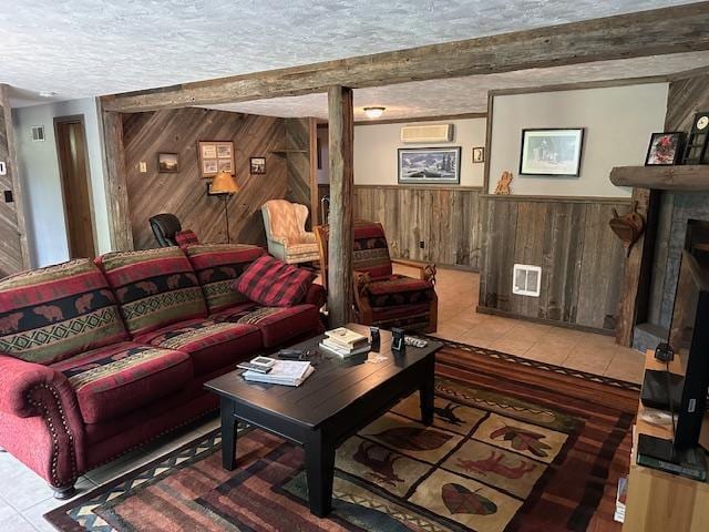 26722 Eisenmen Dr, Leonard, MN 56652 - living room featuring wood walls, tile patterned floors, a wall unit AC, a textured ceiling, and wainscoting