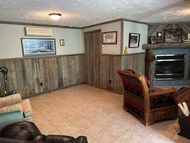 26722 Eisenmen Dr, Leonard, MN 56652 - living area with a wainscoted wall, a wall mounted AC, crown molding, wooden walls, and a large fireplace