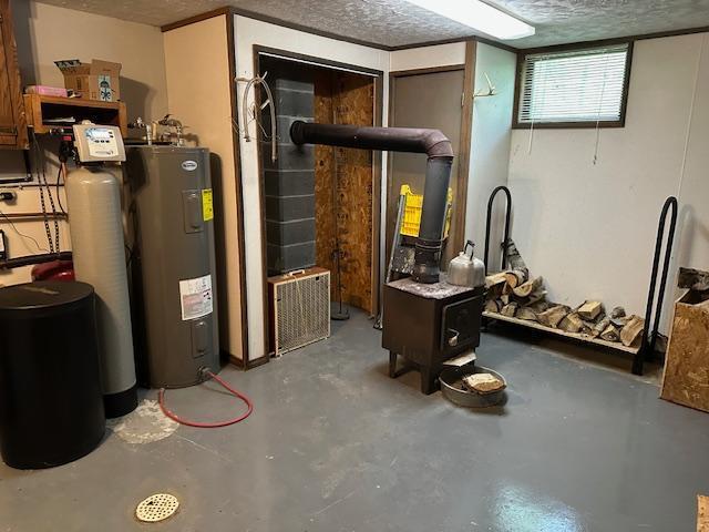 26722 Eisenmen Dr, Leonard, MN 56652 - basement featuring water heater, a textured ceiling, and a water softener