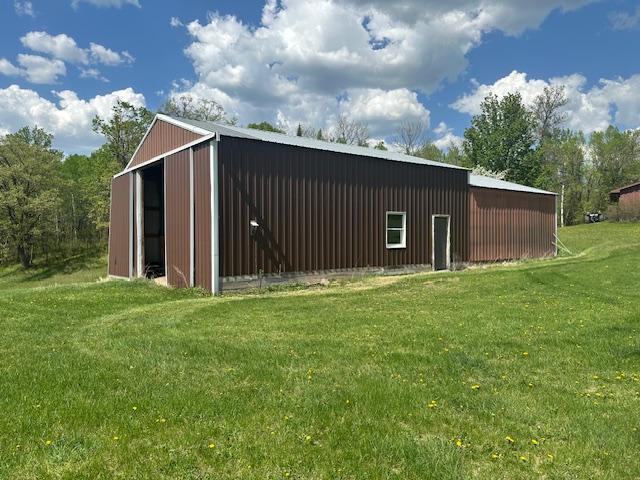 26722 Eisenmen Dr, Leonard, MN 56652 - view of pole building featuring a yard