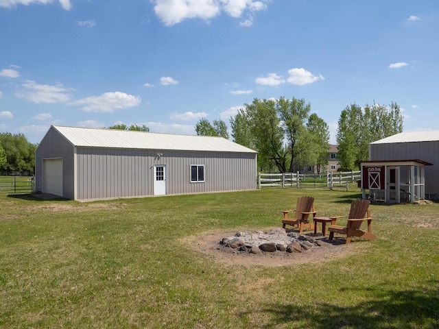 9368 188th Ave NW, Nowthen, MN 55330 - view of yard featuring an outbuilding, an outdoor fire pit, and a detached garage