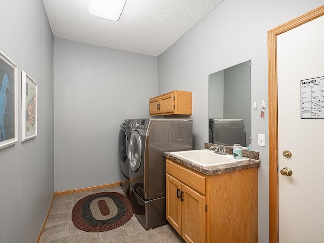 9368 188th Ave NW, Nowthen, MN 55330 - laundry room featuring separate washer and dryer, light tile patterned floors, a textured ceiling, and cabinet space