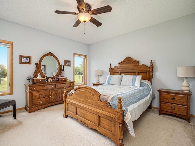9368 188th Ave NW, Nowthen, MN 55330 - bedroom featuring light carpet, multiple windows, and a ceiling fan