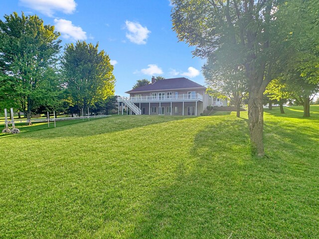 16 Pheasant Dr, Mason Twp, MN 56172 - view of grassy yard featuring a wooden deck and stairway