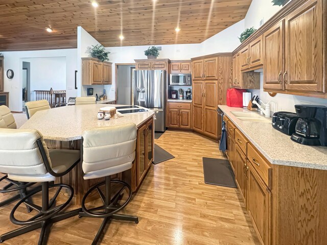 16 Pheasant Dr, Mason Twp, MN 56172 - kitchen with stainless steel appliances, a sink, a breakfast bar area, brown cabinetry, and wooden ceiling