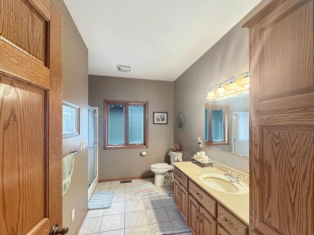 16 Pheasant Dr, Mason Twp, MN 56172 - bathroom with a shower with door, toilet, vanity, tile patterned flooring, and baseboards